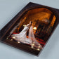 Angled view of a high-gloss acrylic wall print of a bride in a candlelit castle doorway