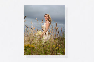 Portrait canvas print of a bride standing in a wildflower meadow