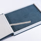 Deep Sea Blue velvet wedding album with engraved cover text, inside its open matching album box
