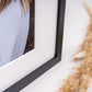 Close-up of a black photo frame and white mount