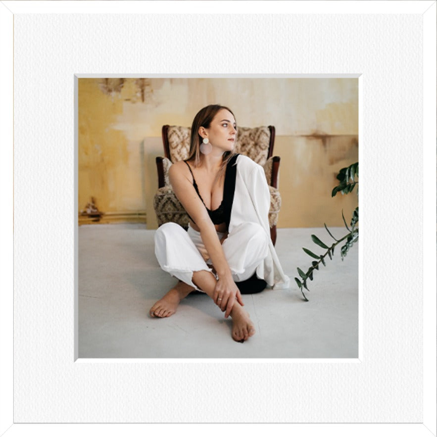 Square framed photo print in a white frame with a white mount