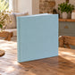 Pigeon Blue linen wedding album standing on a rustic wooden table in a sunlit kitchen